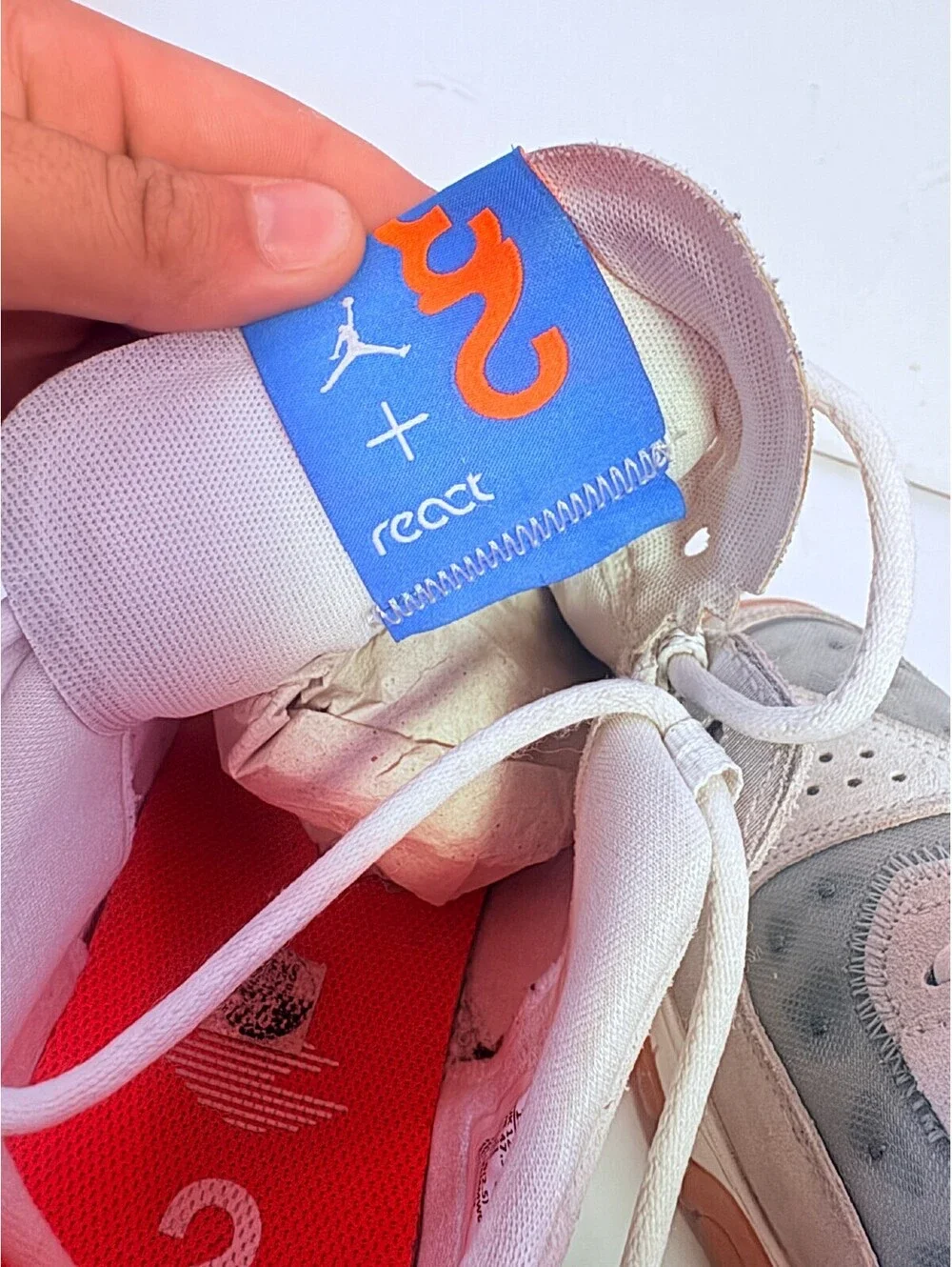 Jordan React white gray sneakers with orange outsole